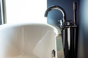bathtub-faucet-closeup-with-luxury-living-concept