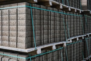 pallets-with-stacked-gray-paving-slabs-selective-focus-stack-paving-slabs-warehouse-road-repair-finished-tile-sale-space-text